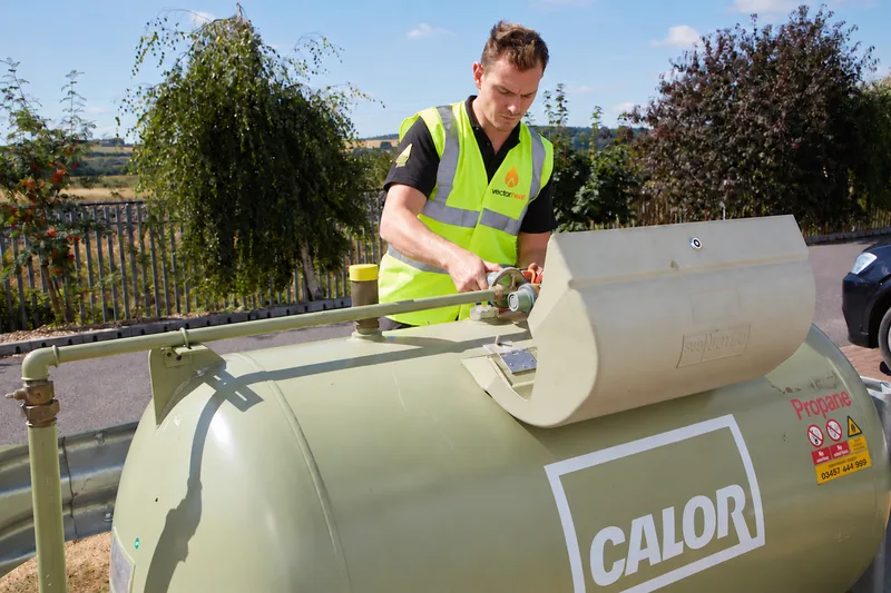 Vector Heat engineer working on an LPG bulk tank