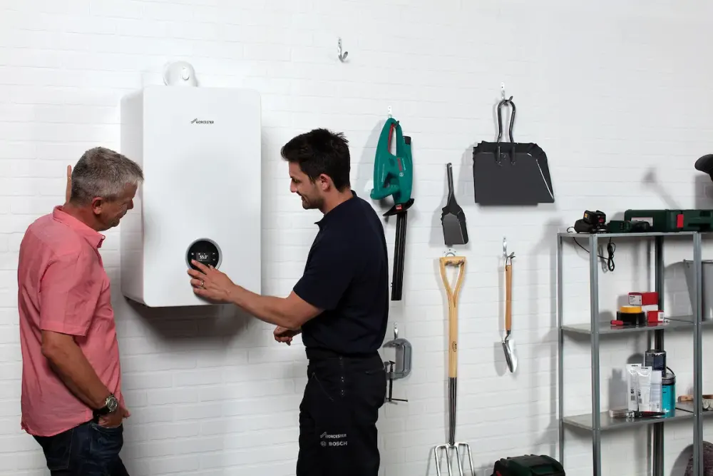 Vector Heat engineer explaining Worcester Bosch boiler controls to a customer
