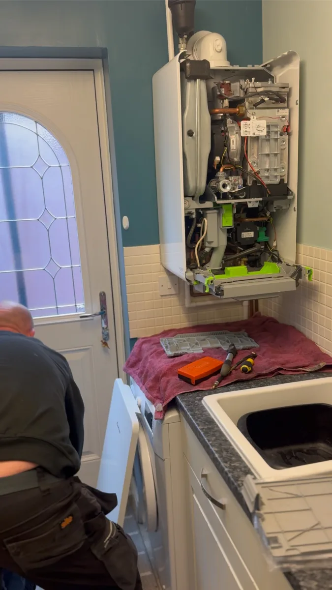 Vector Heat engineer checking a boiler after a water leak