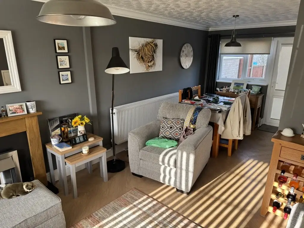 Triple-panel radiator along the wall of a living and dining room