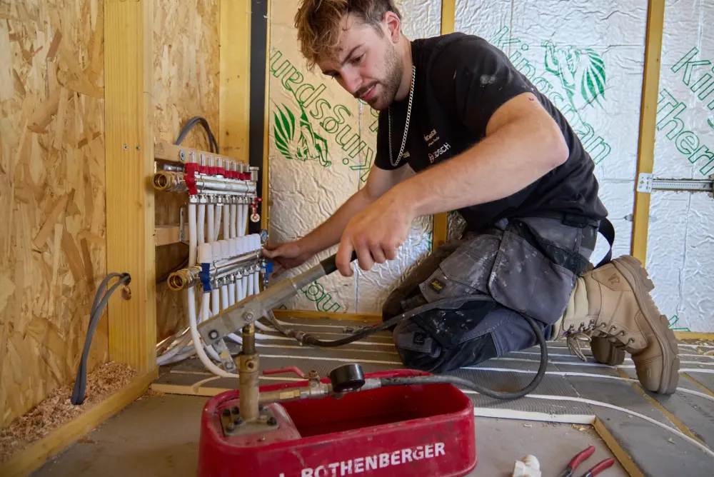 Vector Heat engineer testing a wet underfloor heating manifold on site