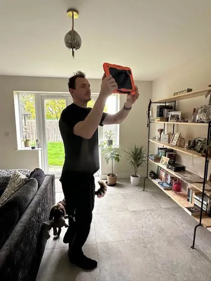 Liam using the Heat Geek iPad scanner during a room survey