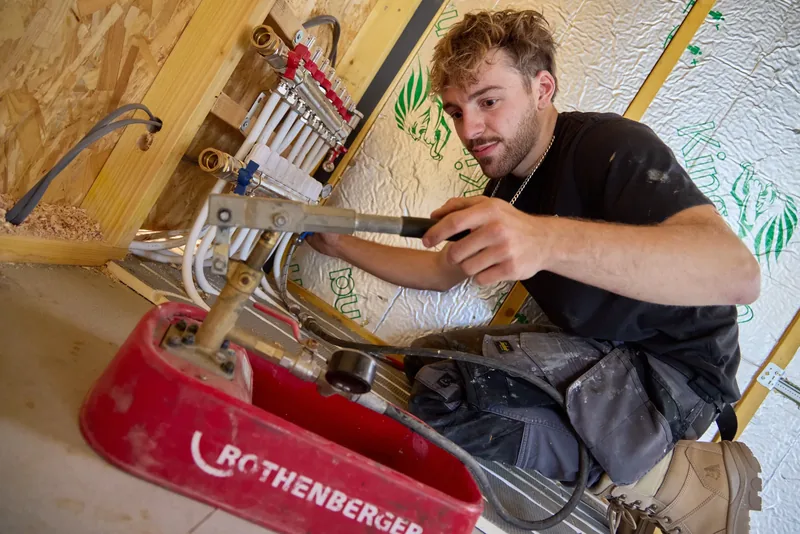 Vector Heat engineer pressure testing an underfloor heating manifold