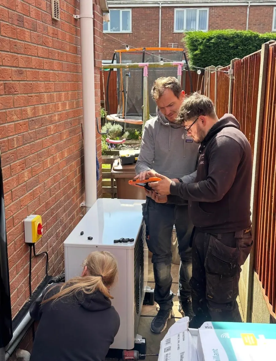 Vector Heat engineers commissioning a Vaillant heat pump using a tablet